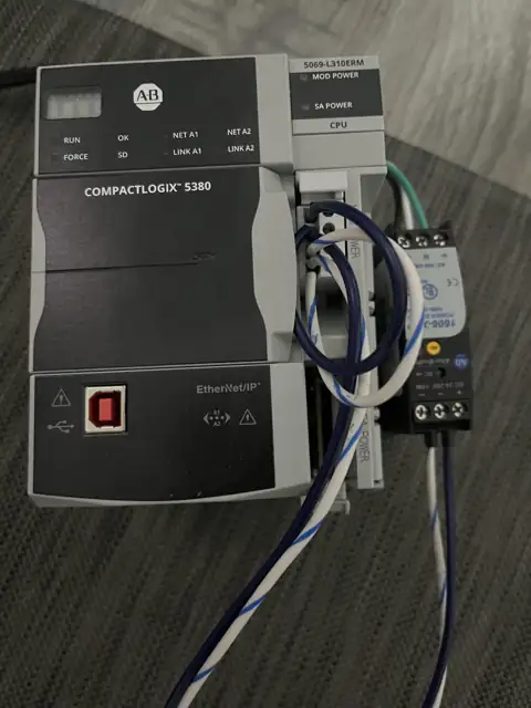 Allen-Bradley CompactLogix 5380 controller, catalog 5069-L310ERM, wired to a 24V DC power supply on a test bench